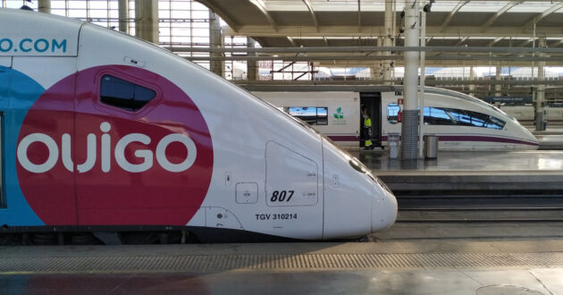 An Ouigo 108 series train with a Renfe 103 in the background at Madrid Puerta de Atocha station. © MIGUEL BUSTOS.